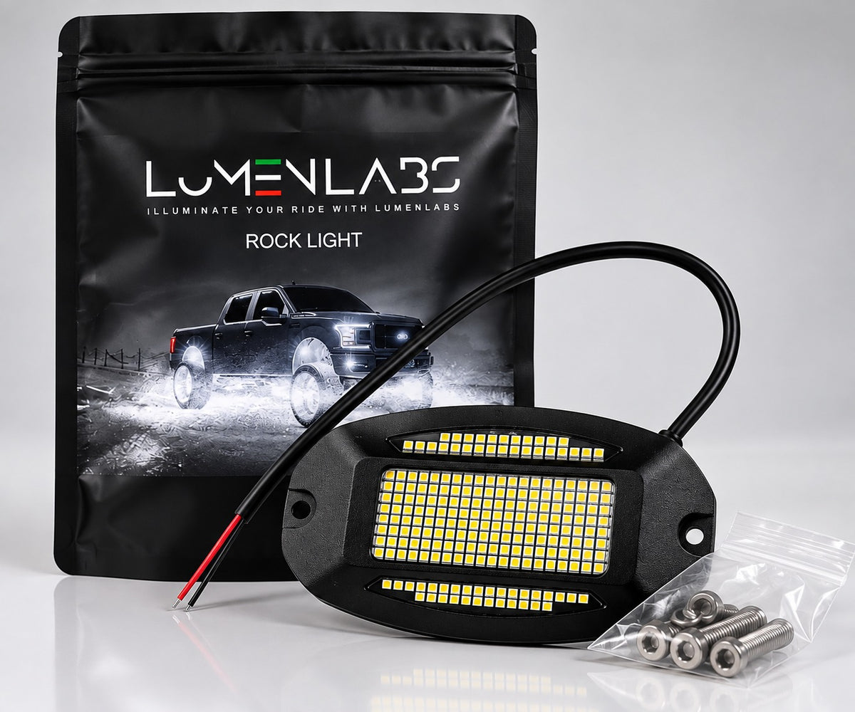 Black LED rock light with Pure White LEDs, red/black wiring leads, and mounting hardware