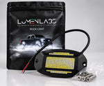 Black LED rock light with Pure White LEDs, red/black wiring leads, and mounting hardware