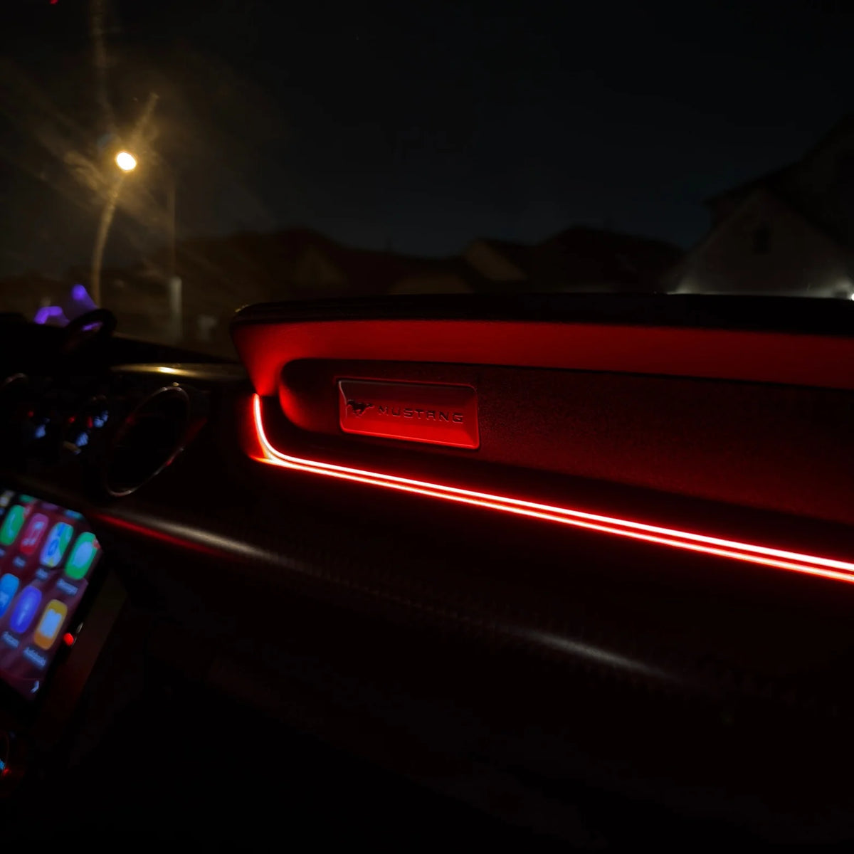 Car door panel ambient LED strip glowing red near handle