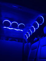 Car audio speaker rings with blue LED halos, multiple circular drivers along ceiling
