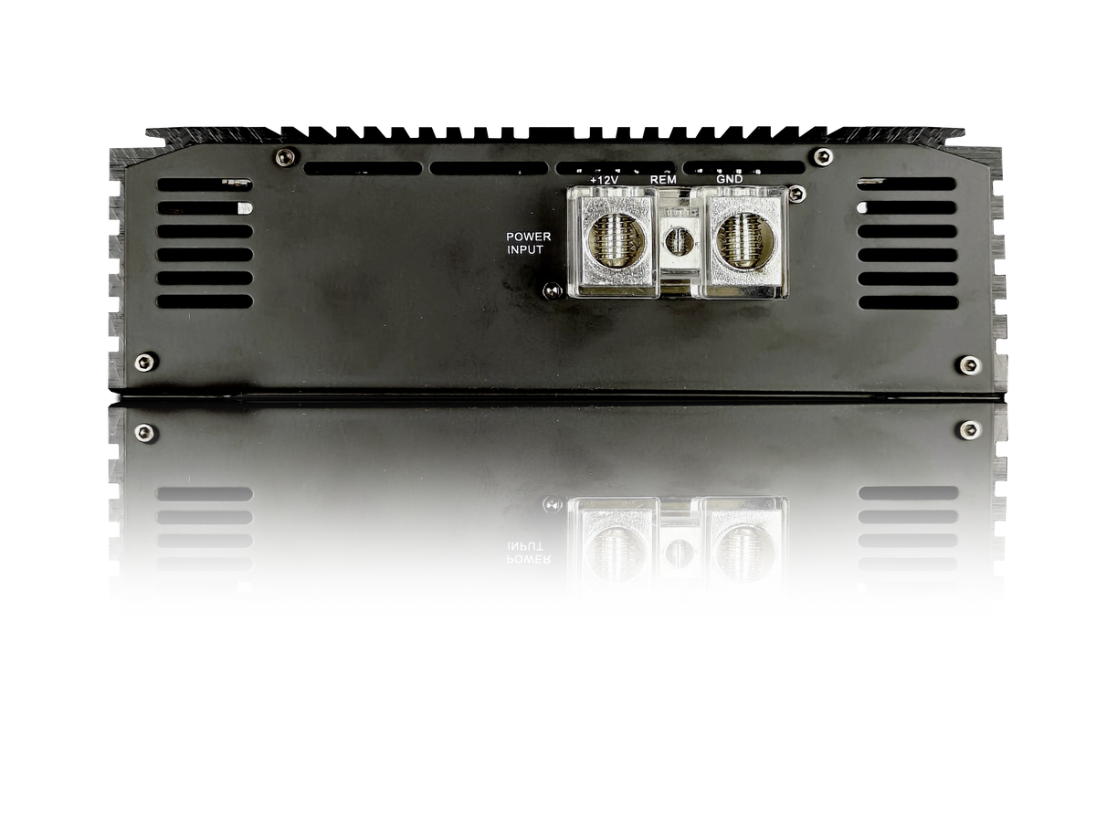 Mono amplifier underside view with terminal blocks on black chassis and heatsink fins